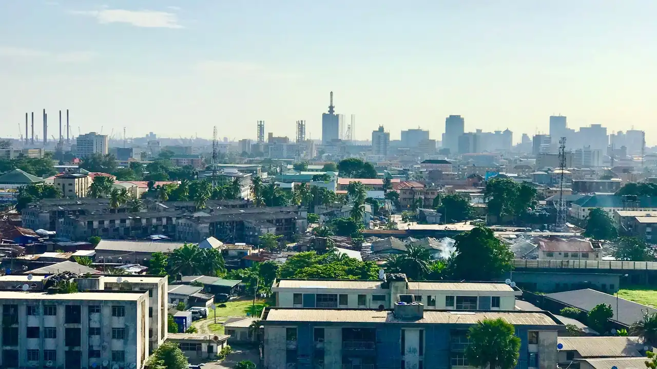 The Lagos skyline, with port cranes on the horizon